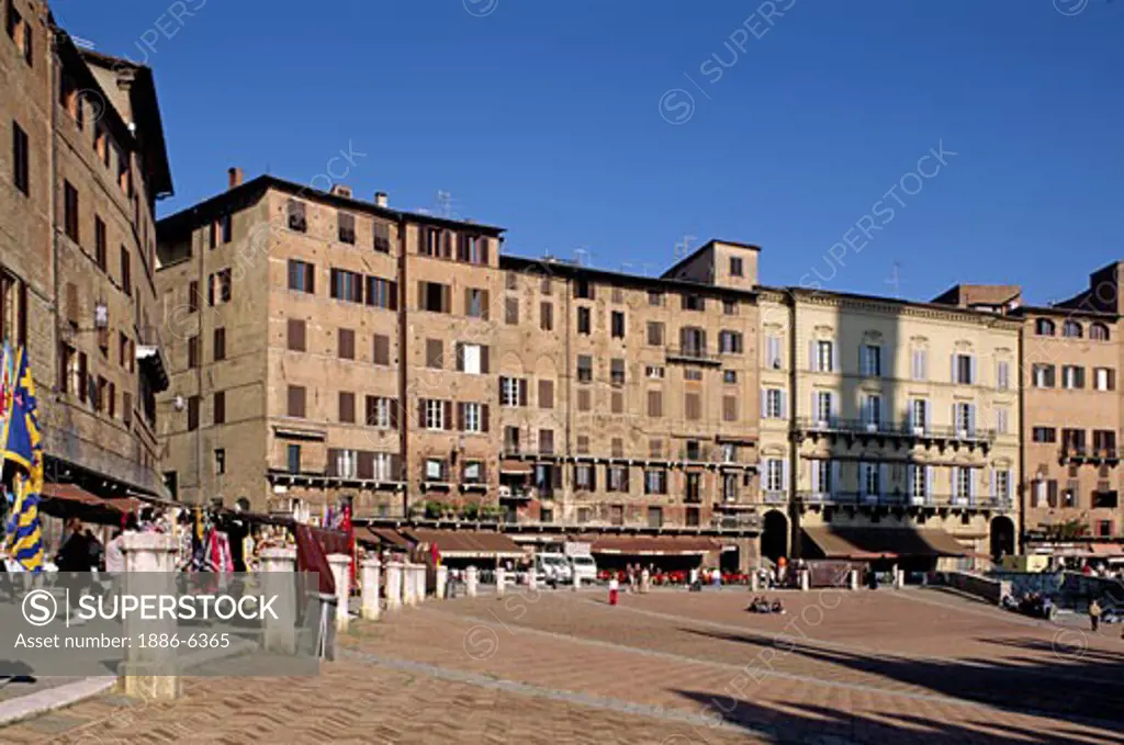 Old palaces with restaurants below line The CAMPO (central plaza) of the MEDIEVAL city of SIENA - TUSCANY, ITALY  