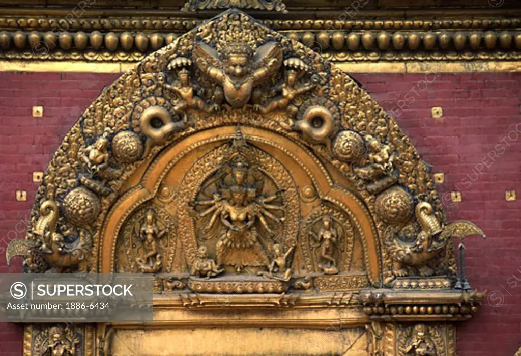 Gold Repousse of the Buddhist deity Avalokiteshwara graces the Sun Dokha or golden gate, created by Jaya Ranjit Malla in 1753 - Bhaktapur, Nepal