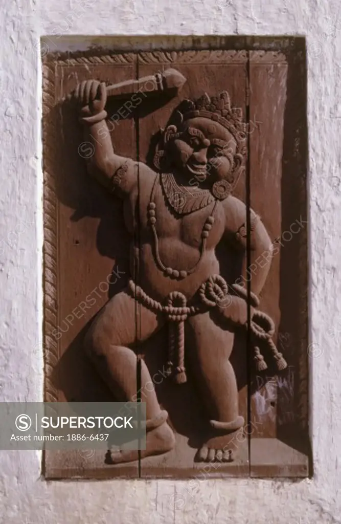 Old wooden carving of the strong man in BHAKTAPUR'S DURBAR SQUARE gate - NEPAL