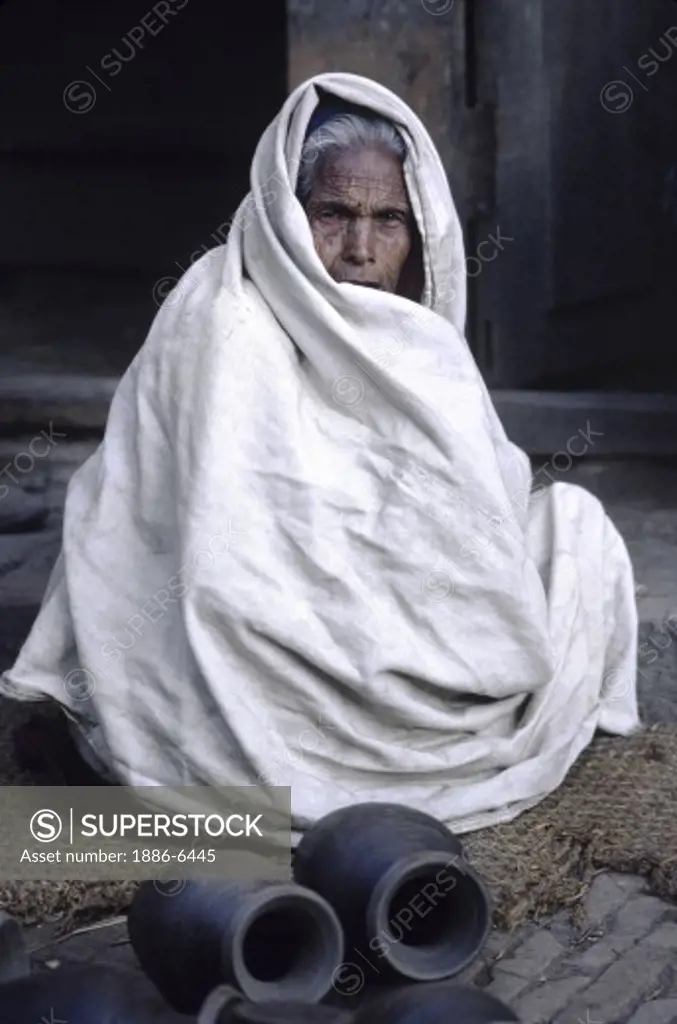 Old woman at the POTTERY BAZAAR - BHAKTAPUR, NEPAL