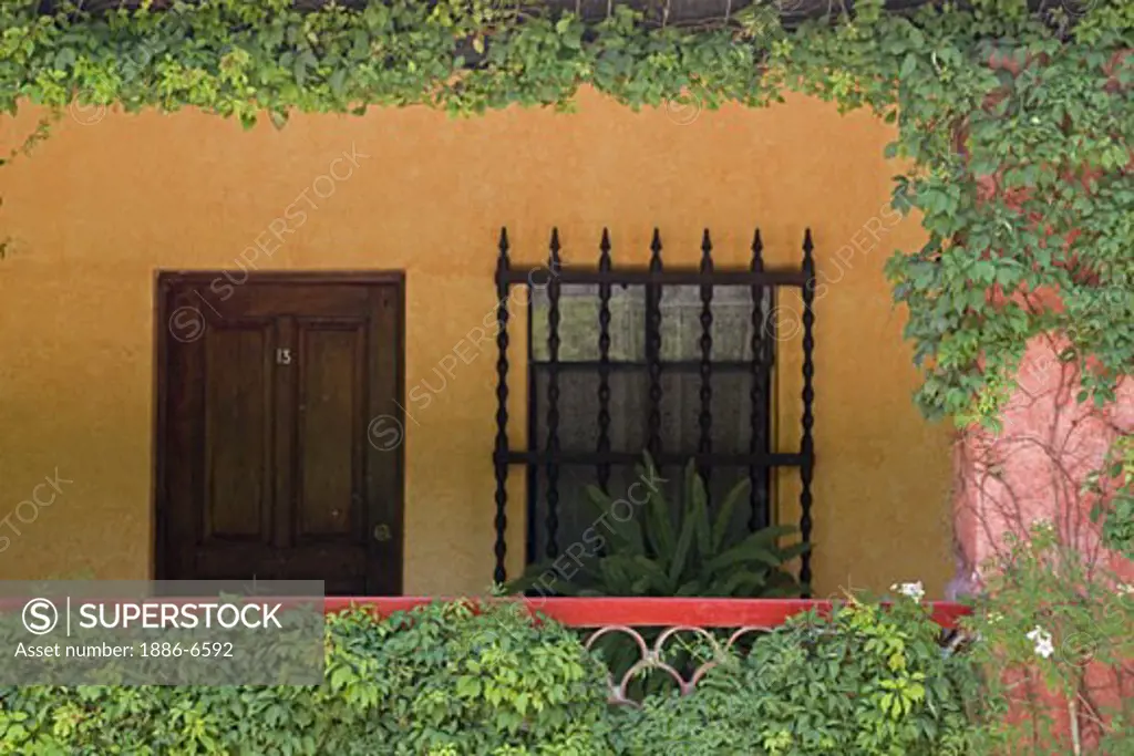 Wrought iron window grate and wooden door create the Mexican style of this hotel in SAN MIGUEL DE ALLENDE - MEXICO 