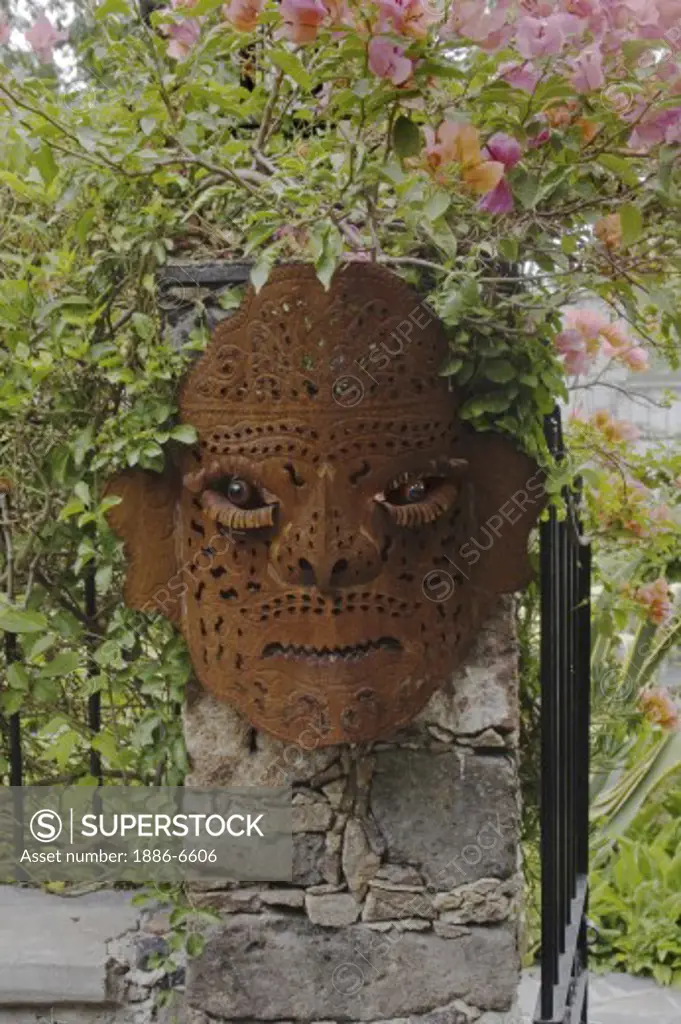 A metal mask in the garden of the bed and breakfast Casa Lisa located in the historic town of San Miguel de Allende - MEXICO 