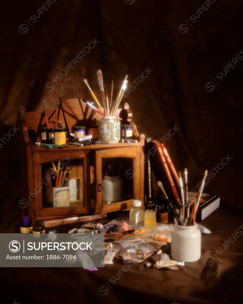 PAINTER'S STILLIFE with BRUSHES, PAINTS, PAINTERS PALLET, PENCILS and BOOKS in a wooden CABINET