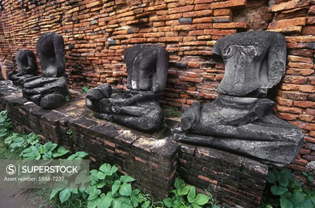 Burmese decapitated STONE BUDDHAS at WAT MAHATHAT built in 1374 AD by King Boromaraja - AYUTTHAYA, THAILAND