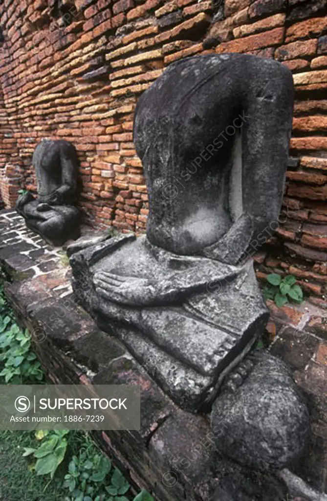 Burmese decapitated STONE BUDDHAS at WAT MAHATHAT built in 1374 AD by King Boromaraja - AYUTTHAYA, THAILAND