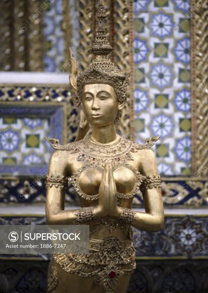 Statue of a BUDDHIST GODDESS at WAT PHRA KEO which is part of the GRAND PALACE complex - BANGKOK, THAILAND 