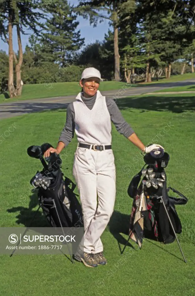 WOMAN GOLFER with GOLFING BAGS at BAYONET GOLF COURSE at Fort Ord on the MONTEREY PENINSULA - CALIFORNIA (MR)