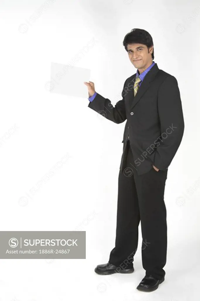 Executive with black suit standing holding paper