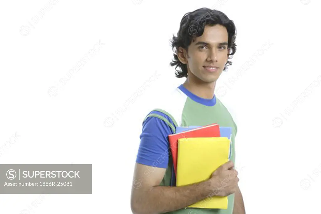 ANG200510 : Teenage boy, holding  books with bright colored covers by one hand, MR #  687T