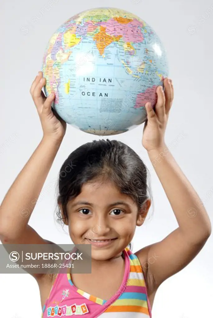 South Asian Indian girl holding globe above head and smiling MR#682N