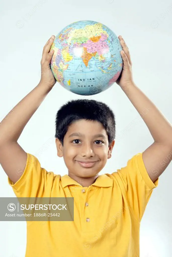 South Asian Indian boy holding globe above head and smiling MR#152