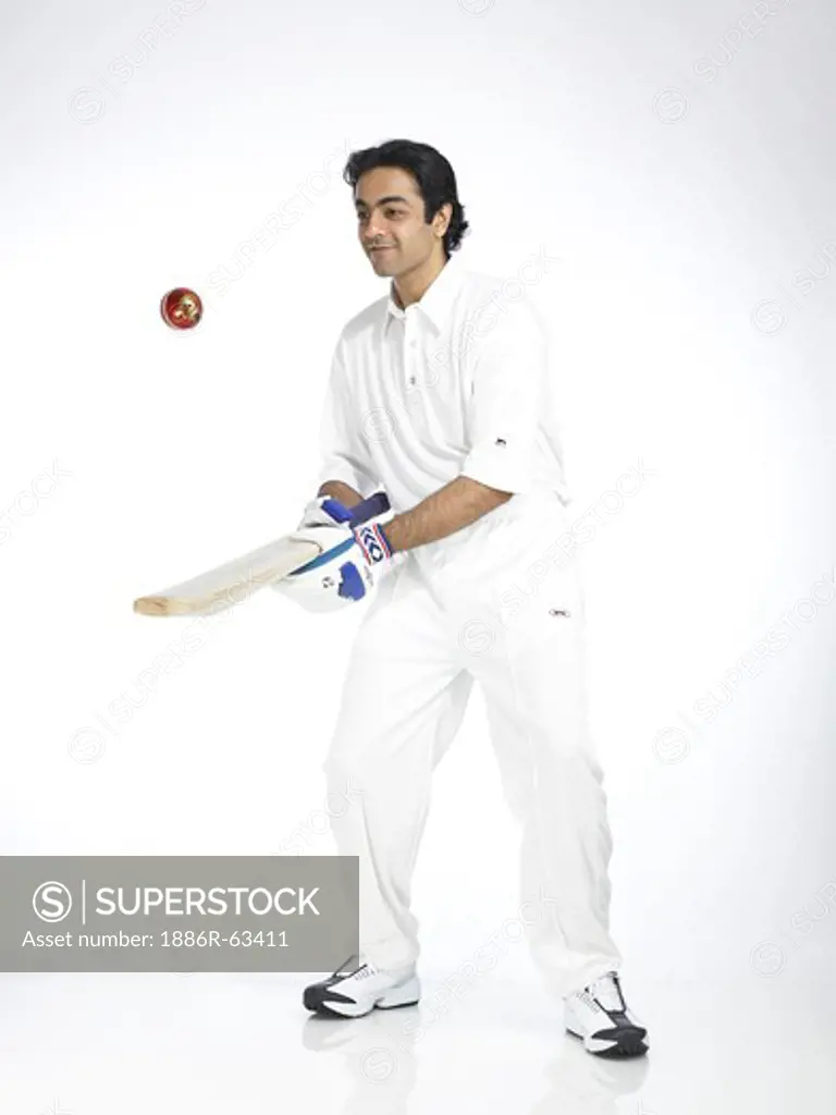 Indian batsman bouncing ball in air with bat