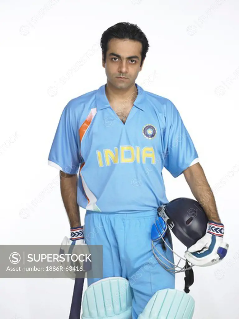 Indian batsman holding bat and helmet ready for cricket match