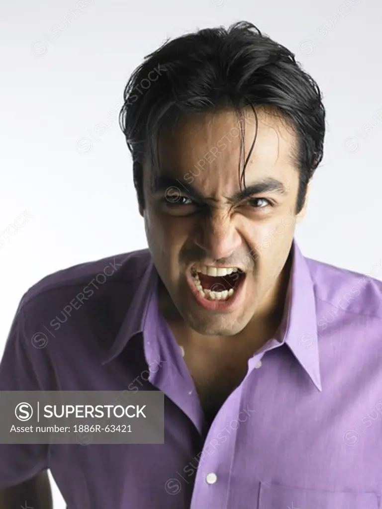 Close up of South Asian Indian man showing frustrated facial expression