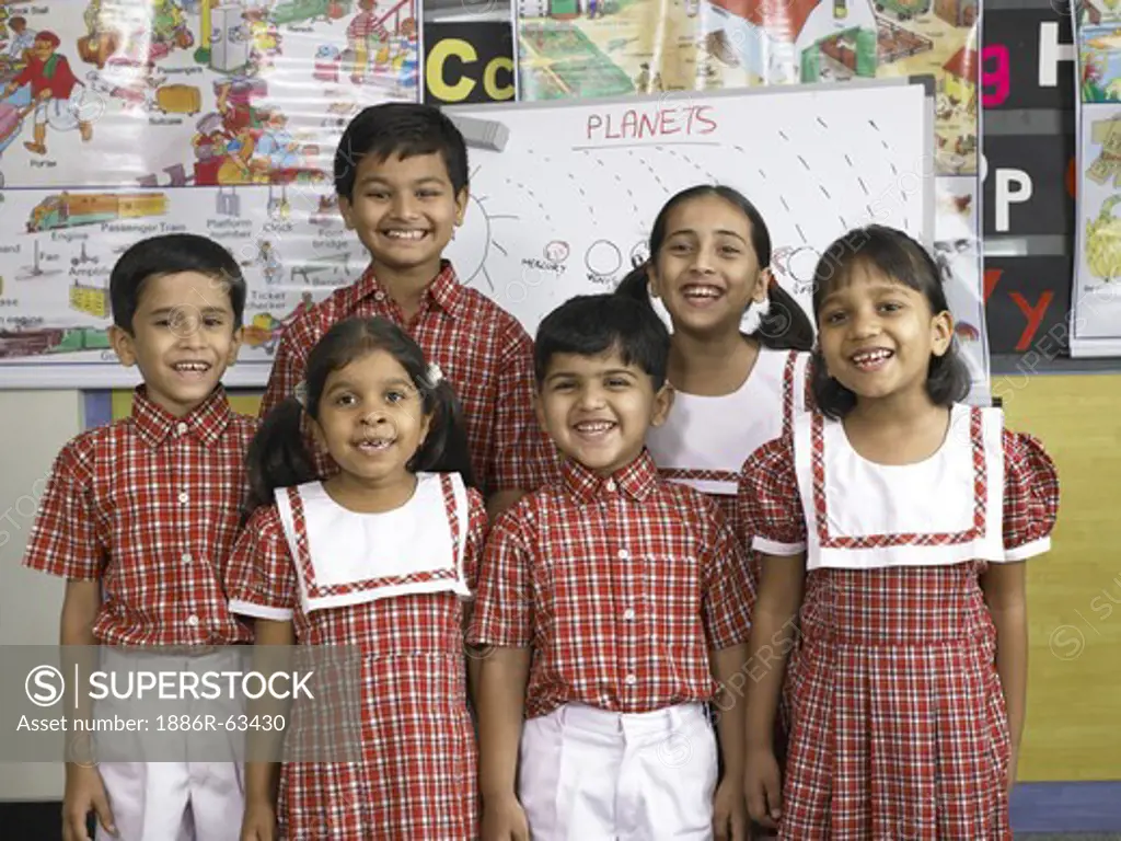 South Asian Indian boys and girls standing together in nursery school MR