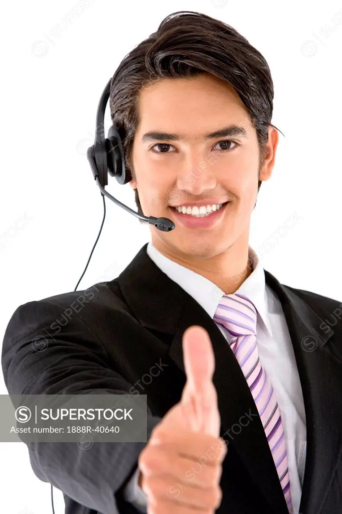 Thumbs_up business man with headset isolated on white