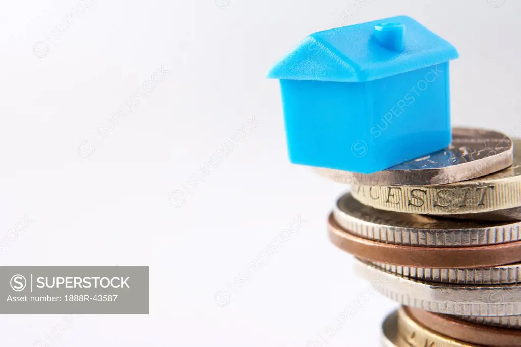 Small model house and coins