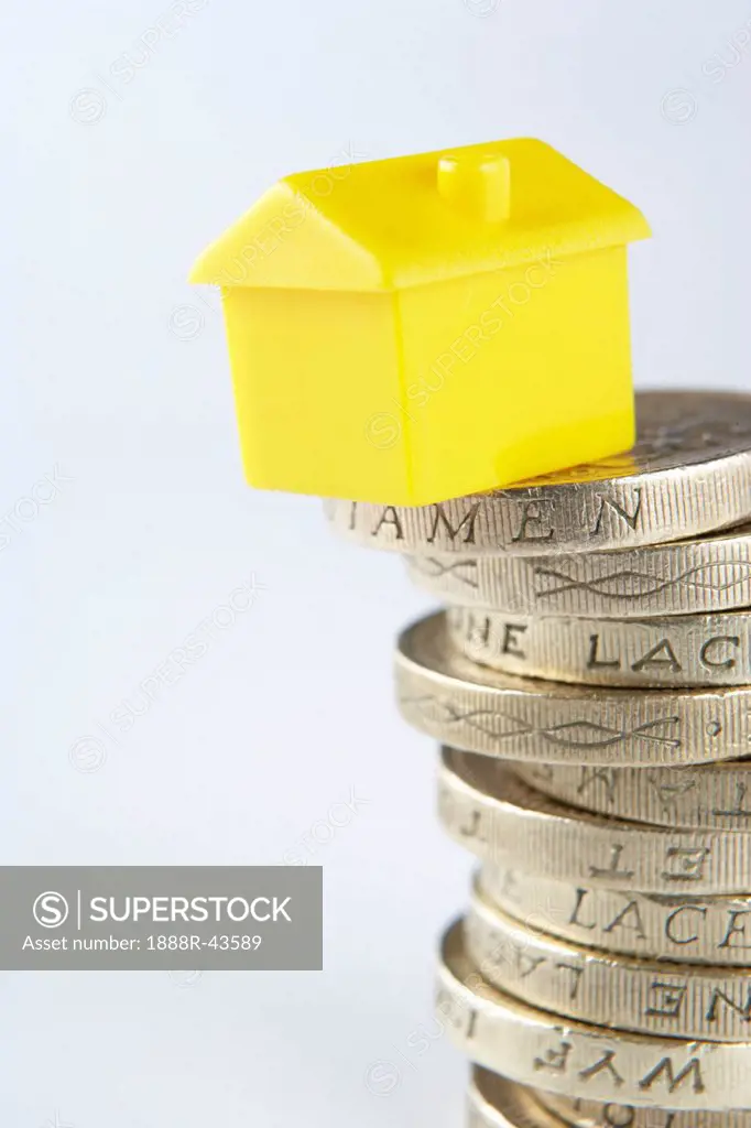 Small model house and coins