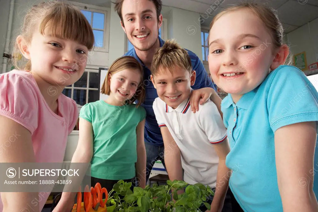 Teacher with children learning about plants