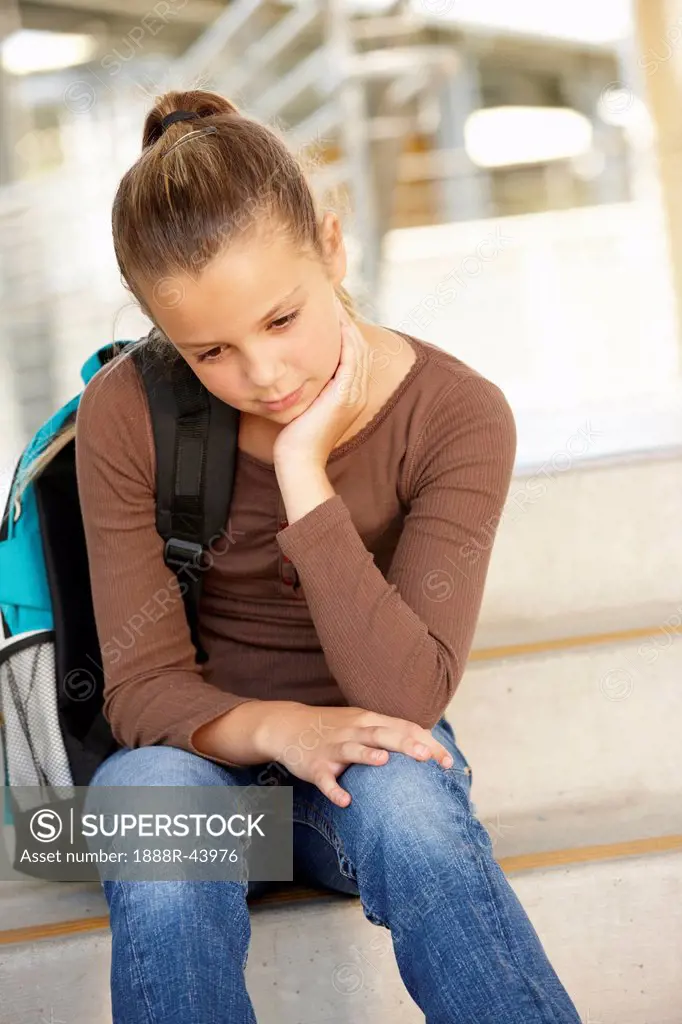 Unhappy Pre teen girl in school
