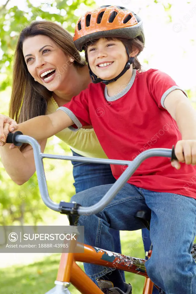 Boy on bike with mother