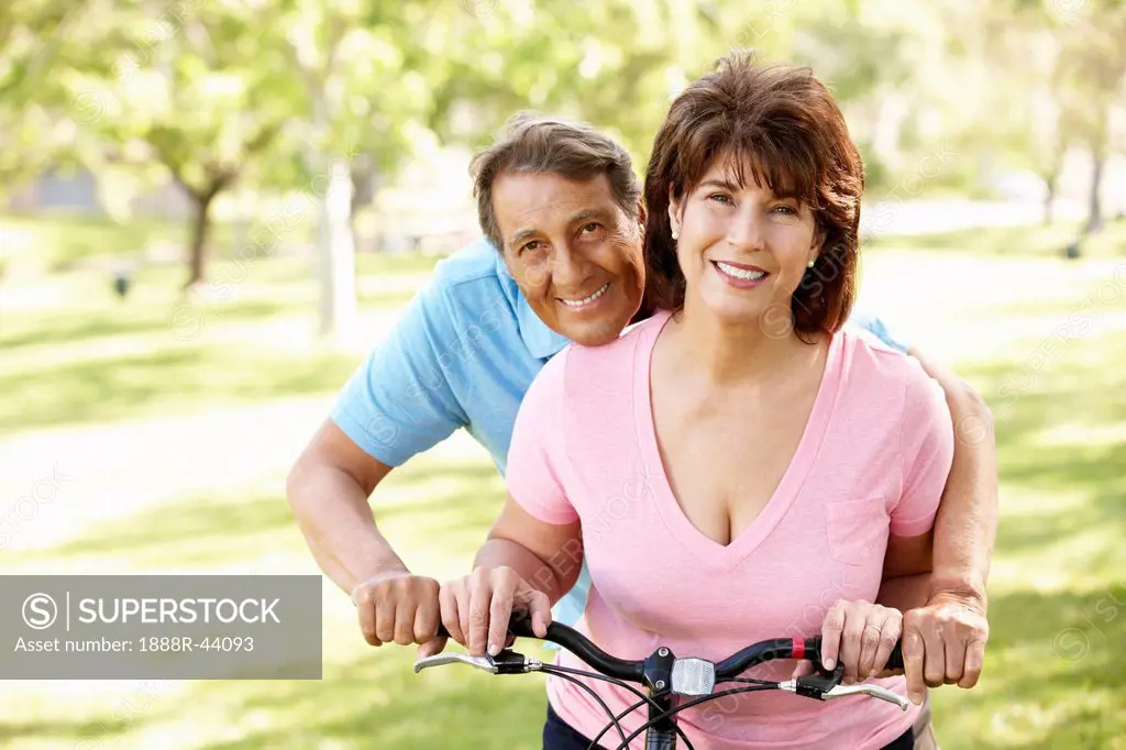 Senior Hispanic couple with bike