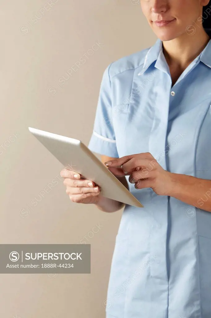 UK nurse using computer tablet