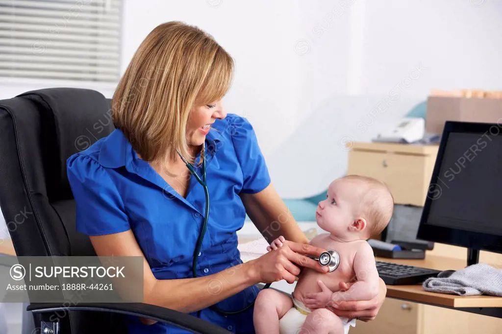 UK doctor examining baby