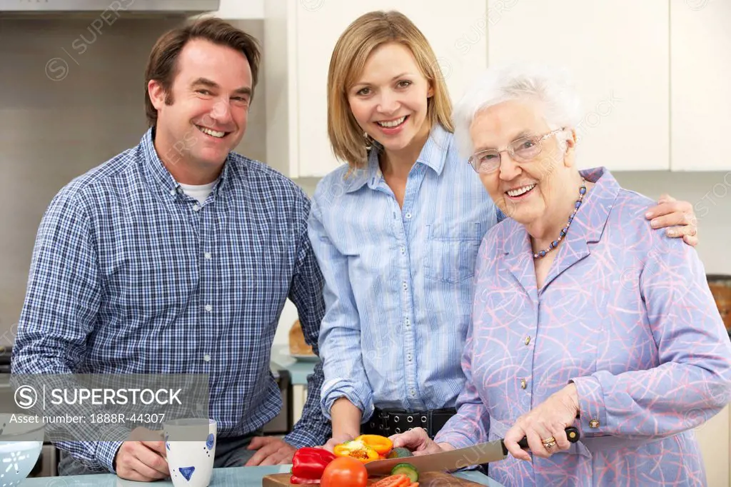 Senior woman and family preparing meal together