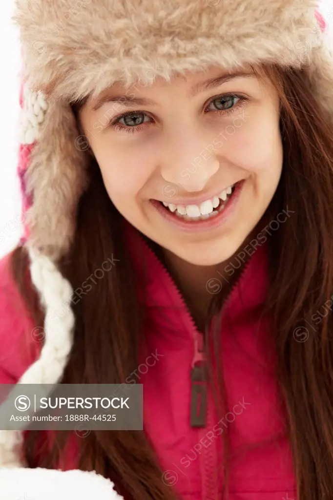 Teenage Girl Holding Snowball Wearing Fur Hat