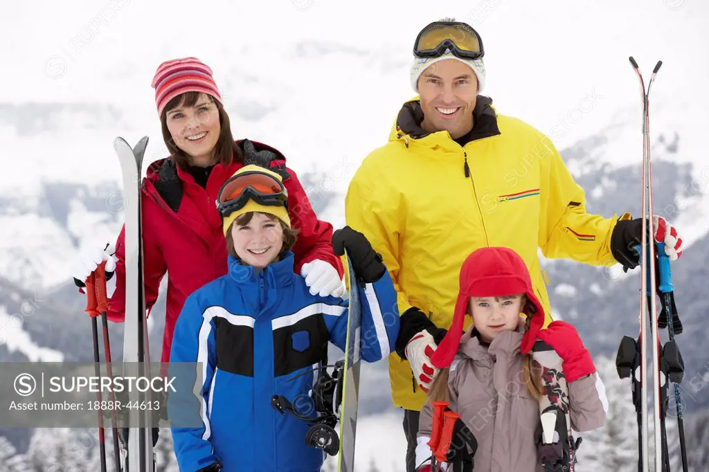 Family On Ski Holiday In Mountains