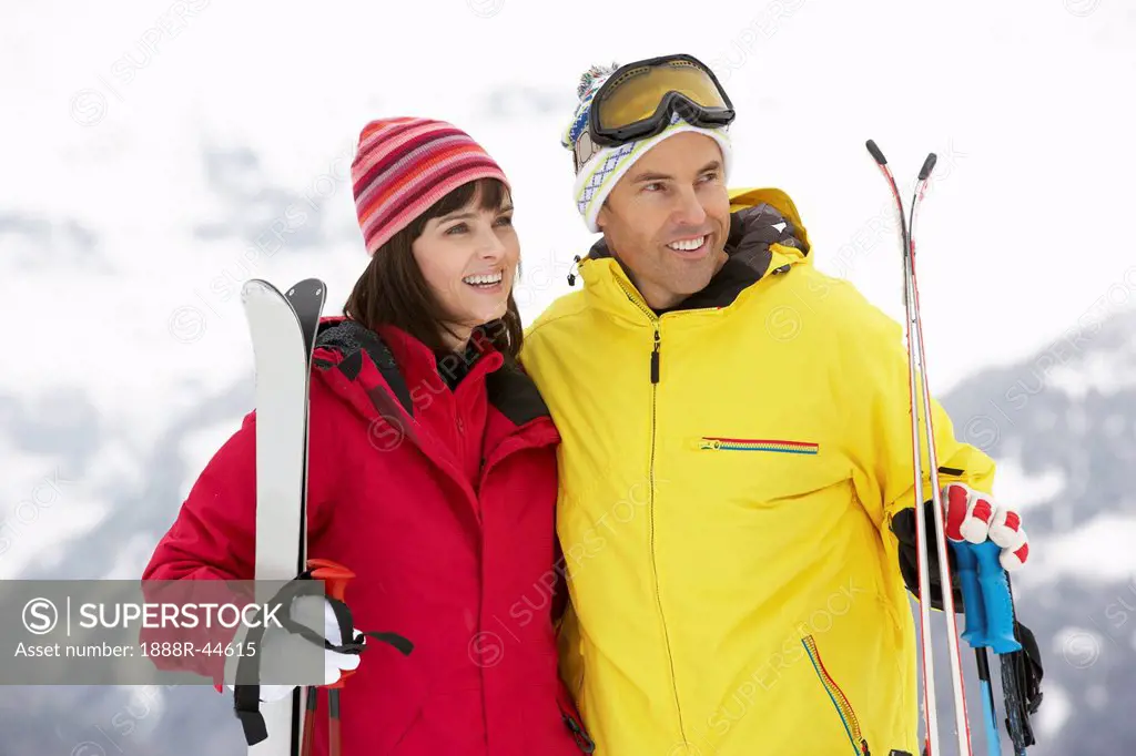 Middle Aged Couple On Ski Holiday In Mountains