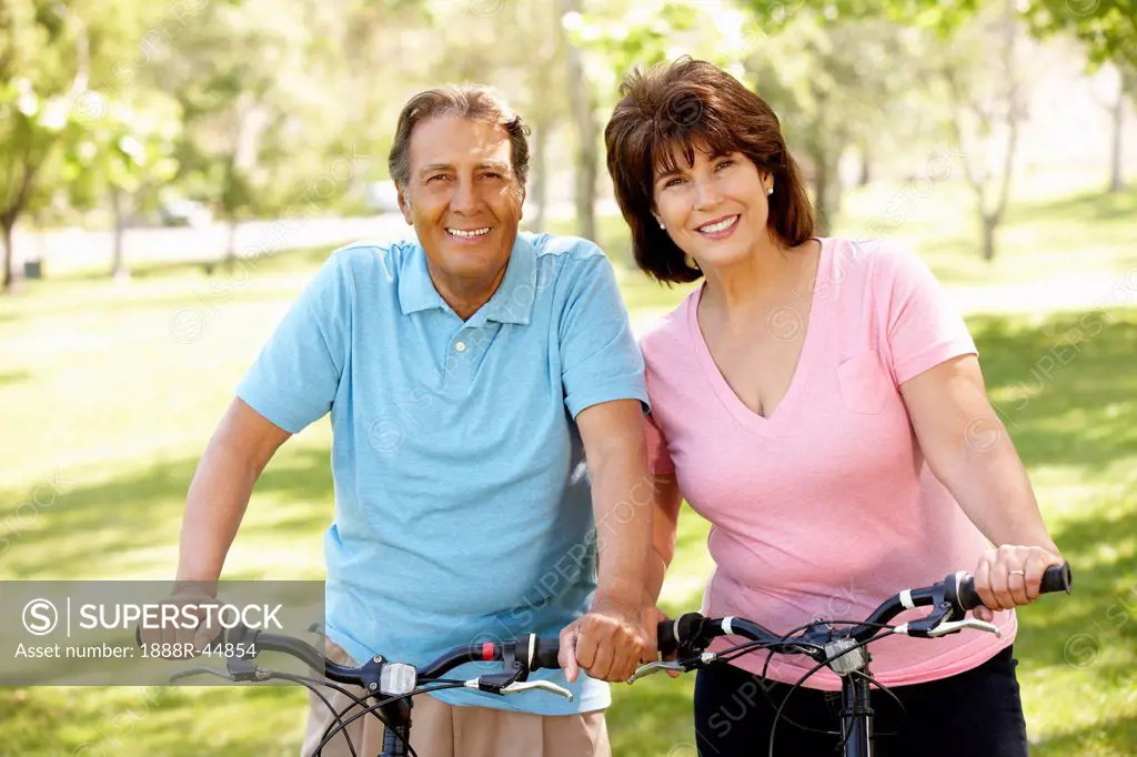 Senior Hispanic couple on bikes