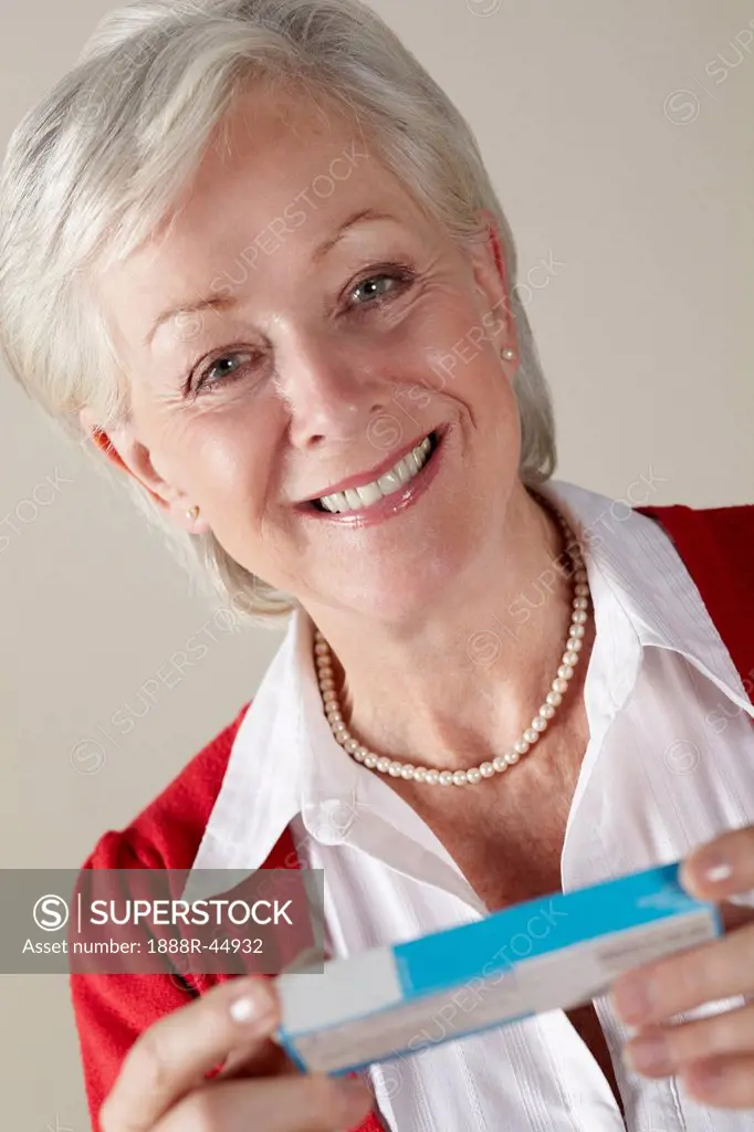 Senior woman holding prescription drug pack