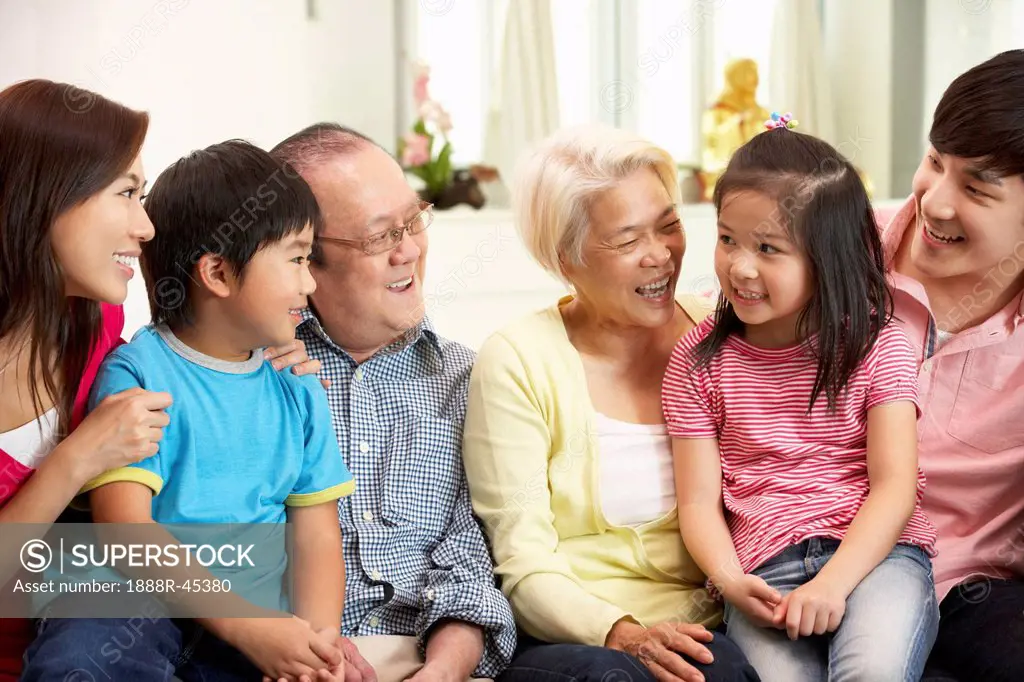 Portrait Of Multi_Generation Chinese Family Relaxing At Home Together