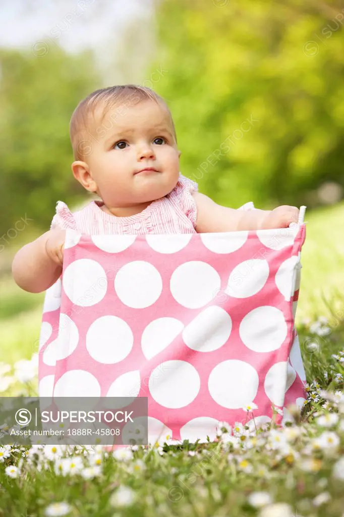 Baby Girl In Summer Dress Sitting In Bag