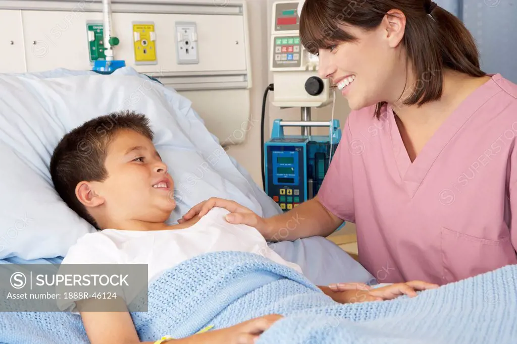 Nurse Visiting Child Patient On Ward