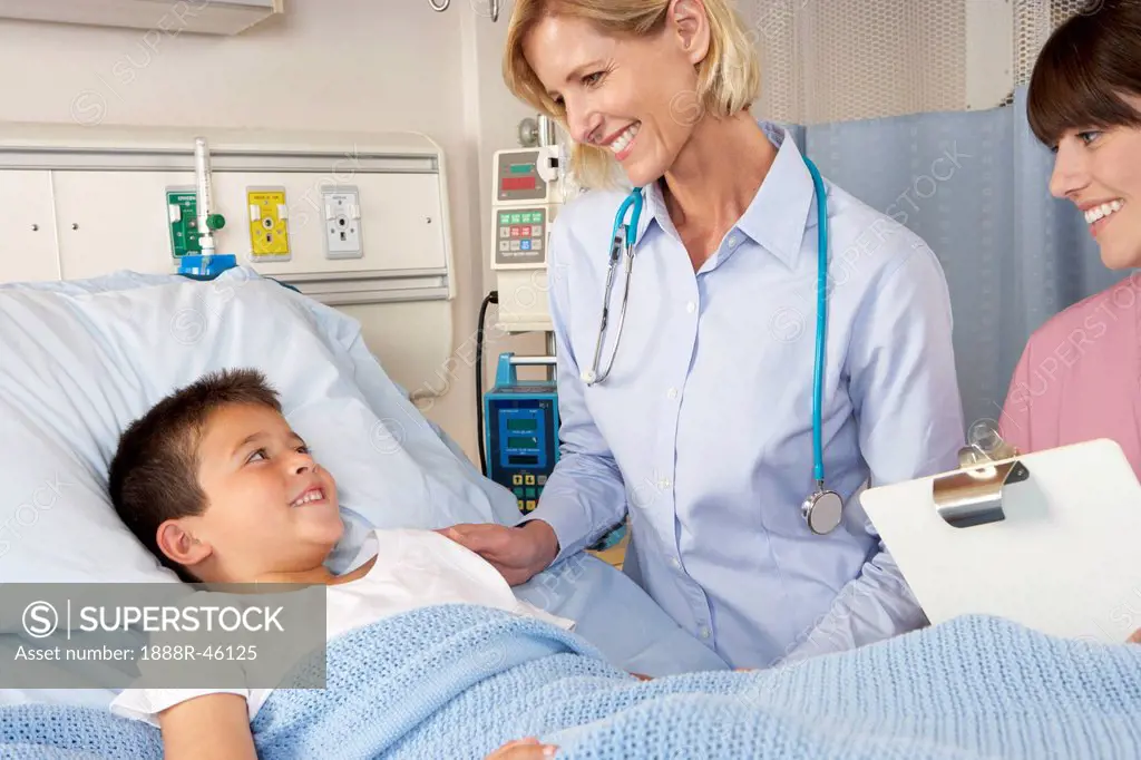 Doctor Visiting Child Patient On Ward