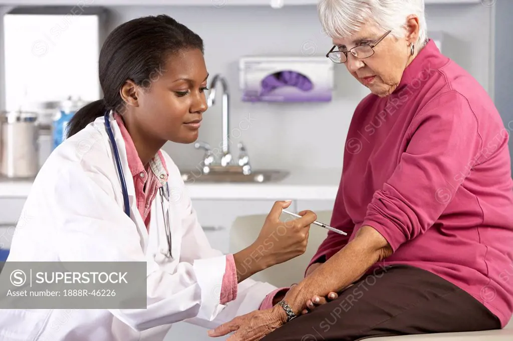 Doctor Giving Senior Female Patient Injection