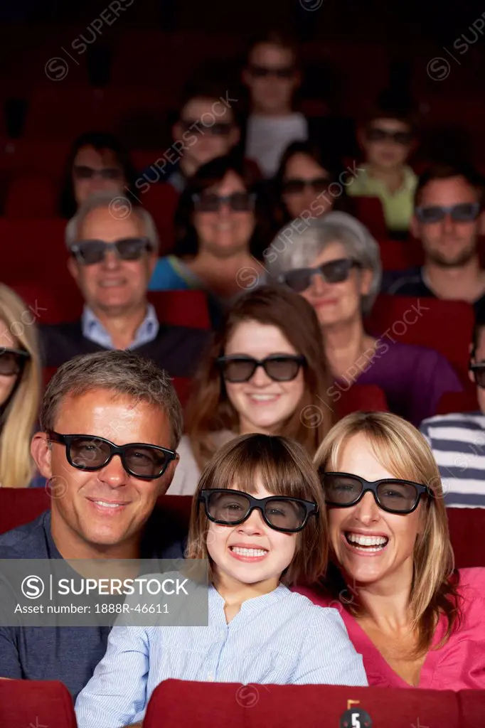 Family Watching 3D Film In Cinema