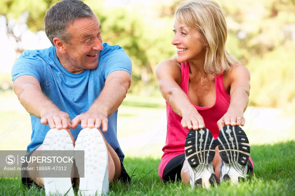 Senior Couple Exercising In Park