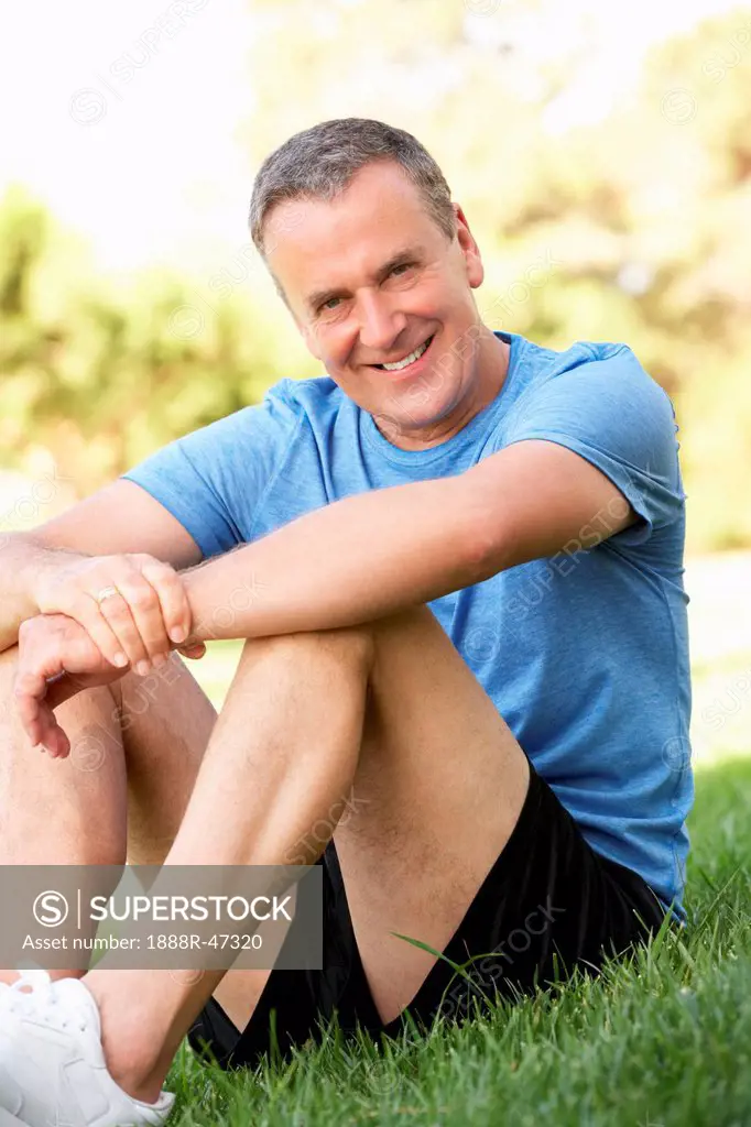Senior Man Resting After Exercising In Park