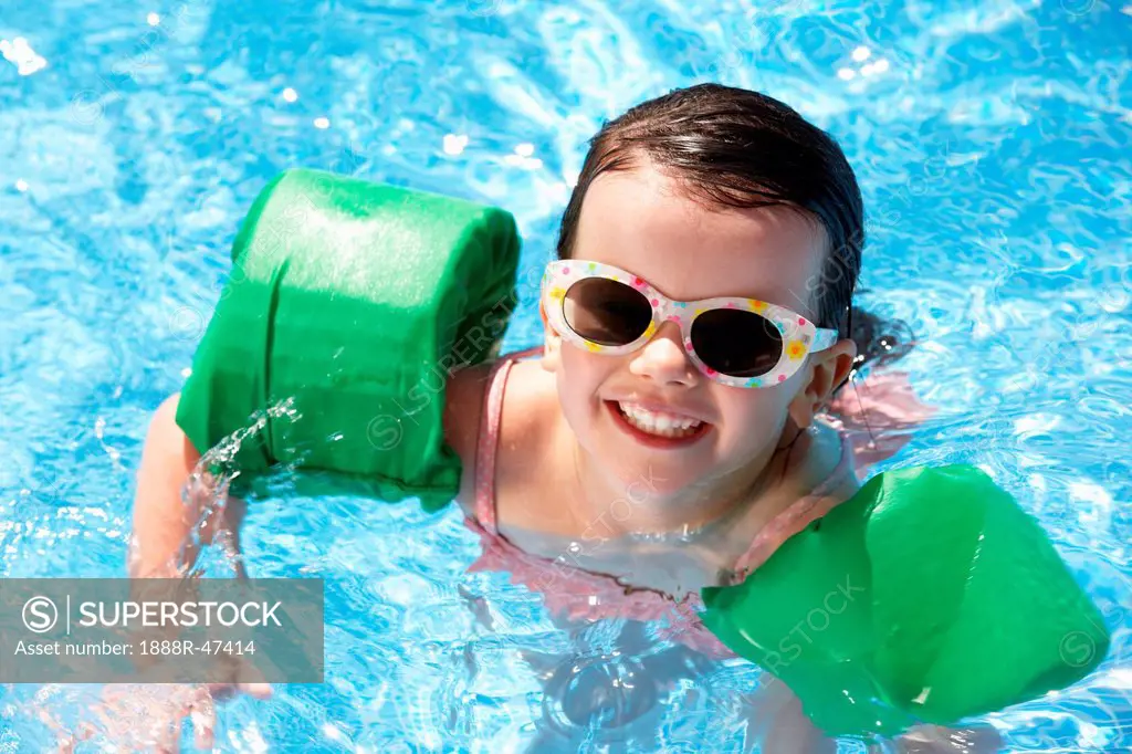 Portrait Of Girl With Armbands In Swimming Pool
