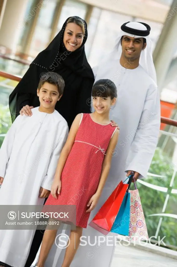 Family standing in mall smiling selective focus