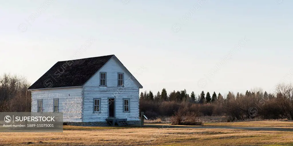 An old white wooden house in Hecla-Grindstone Provincial Park; Manitoba, Canada