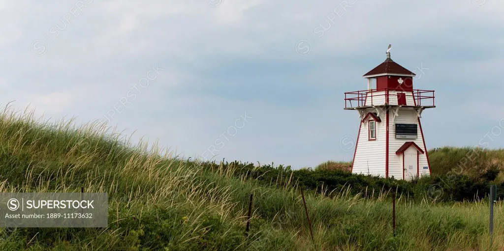 A red and white lighthouse on the Atlantic coast; Prince Edward Island, Canada