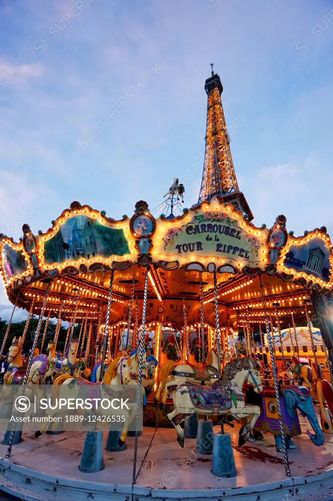 Carousel By The Eiffel Tower In The Evening, Paris, France