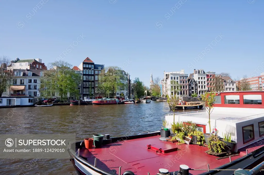 Houseboat And Canal Houses By The Amstel River, Amsterdam, Netherlands