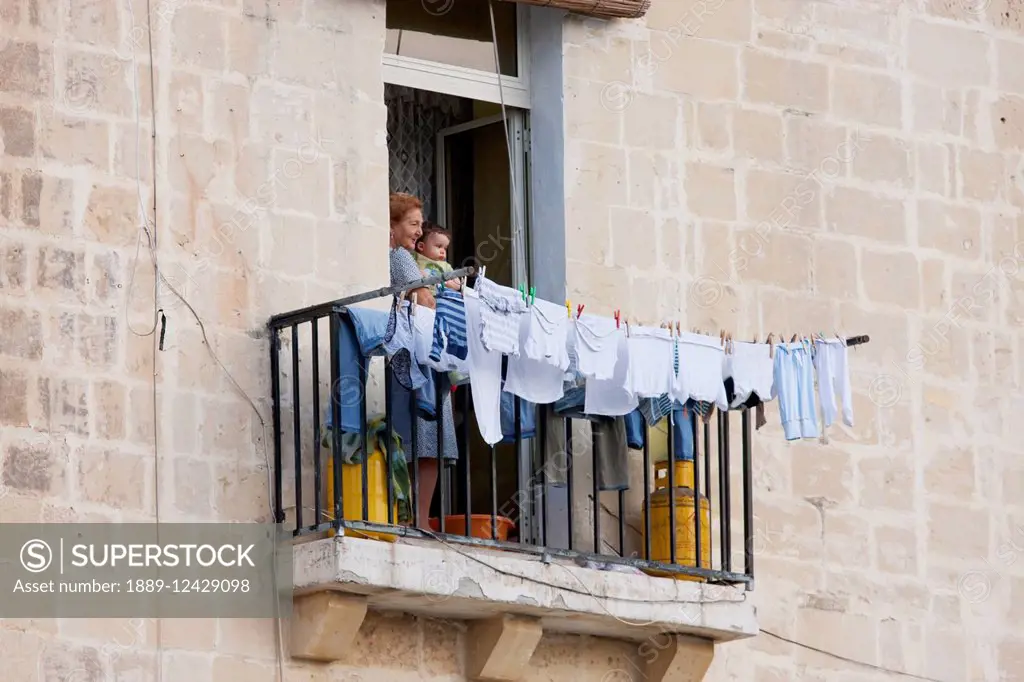 Woman Holding A Boy By A Balcony, Valletta, Malta