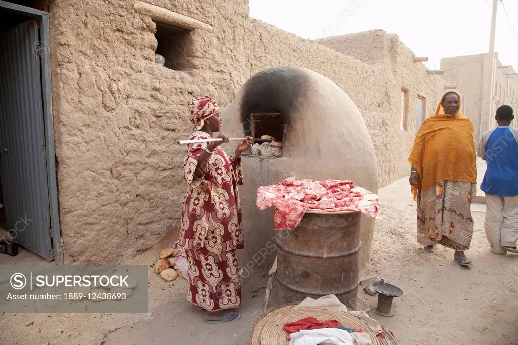 Baking bread in mud oven in Timbuktu, Mali